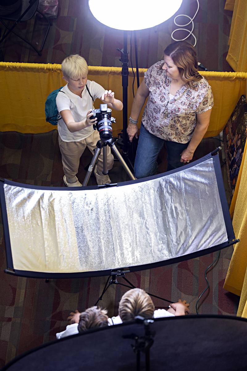 River Bend eighth-grader Tucker Tiesman snaps a picture of his classmates while attending the career booth of photographer Nicole Olinger Friday, Oct. 20, 2023 at Sauk Valley College.