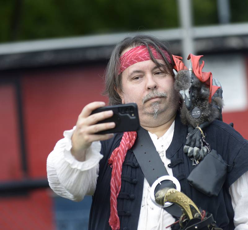 Martin Howard takes a selfie with “Flame Wing” who rests upon his shoulder Saturday, Sept. 14, 2024, during the Marseilles Renaissance Faire.