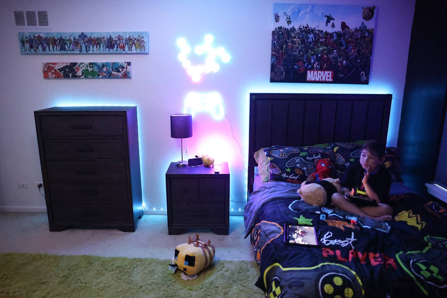 Jorgie Espinoza, 10-years old, sits on the bed of his newly renovated bedroom. Jorgie, who is battling cancer, won an extreme bedroom makeover from Special Places, an organization creating dream bedrooms for children with cancer on Tuesday, Sept. 12, in Joliet.