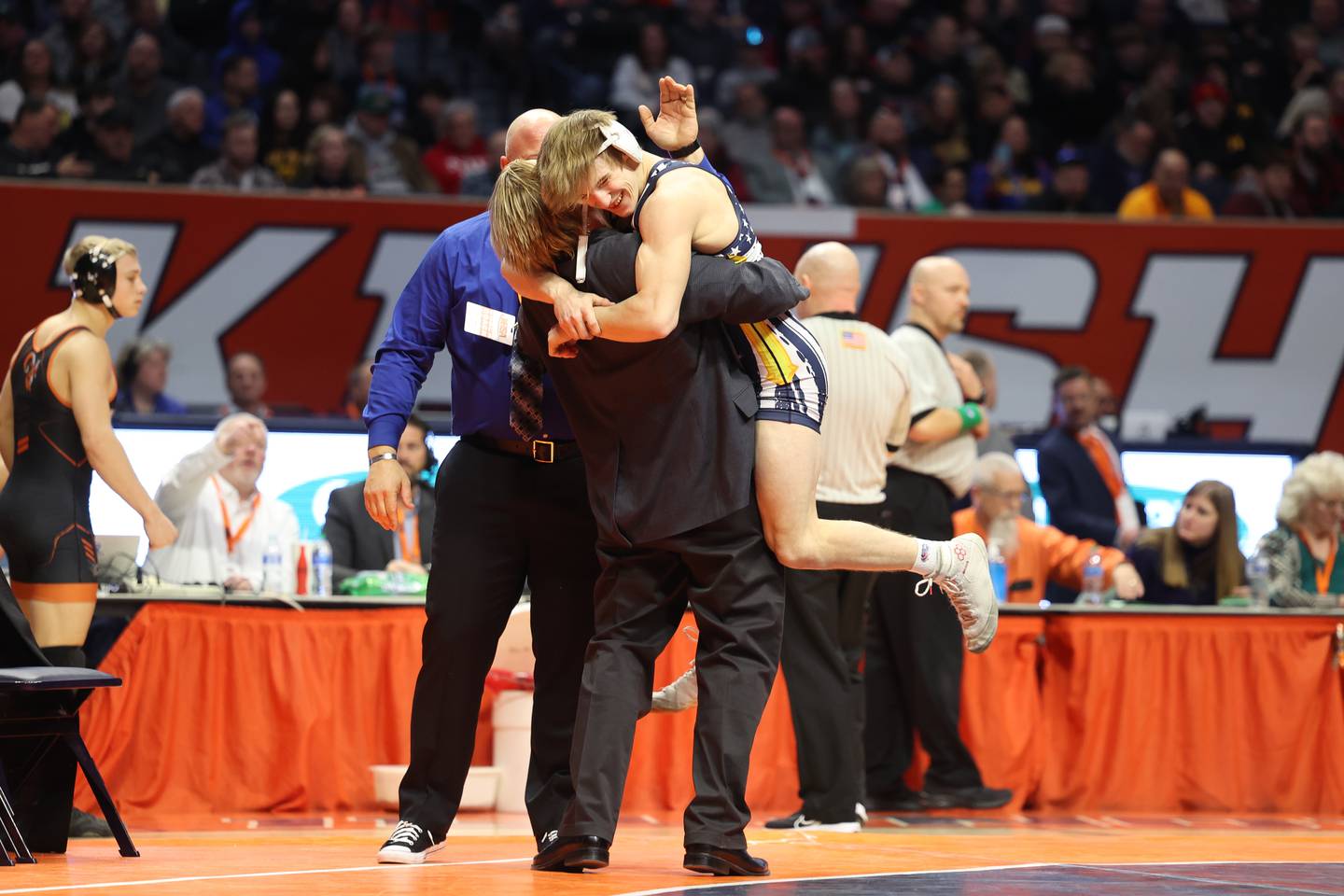 Yorkville Christian’s Ty Edwards jumps into the arms of his coach after his win over Galesburg’s Sauge Shipp in the 132-pound Class 2A state championship match on Saturday, Feb. 17th, 2024 in Champaign.