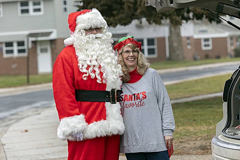 Santa and Mrs. Claus, aka Jon and Joy Colberg stop for pictures during their delivery detail Friday, Dec. 22, 2023 for Operation Santa Claus.