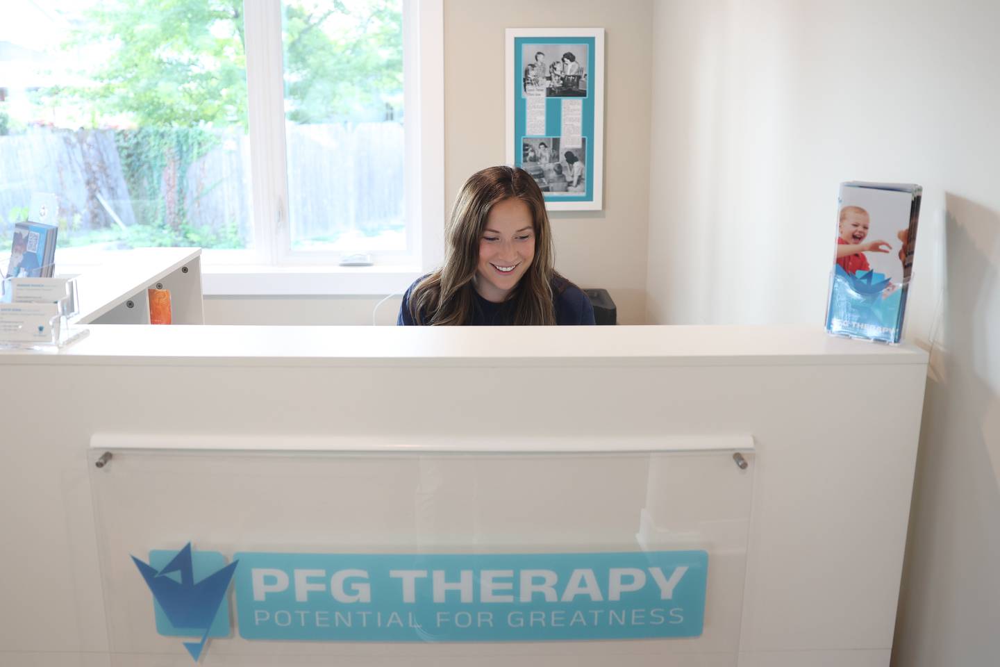 Maggie Ruzich works the front desk at her business PFG Therapy on Tuesday, August 20, 2024 in Plainfield.