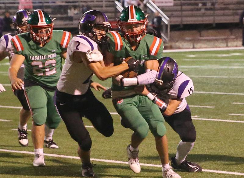 L-P's Noah Zebron carries the ball while Plano defenders Jacob Decker and Kaden Aguirre bring him down on Friday, Sept. 15, 2023 at Howard Fellows Stadium.