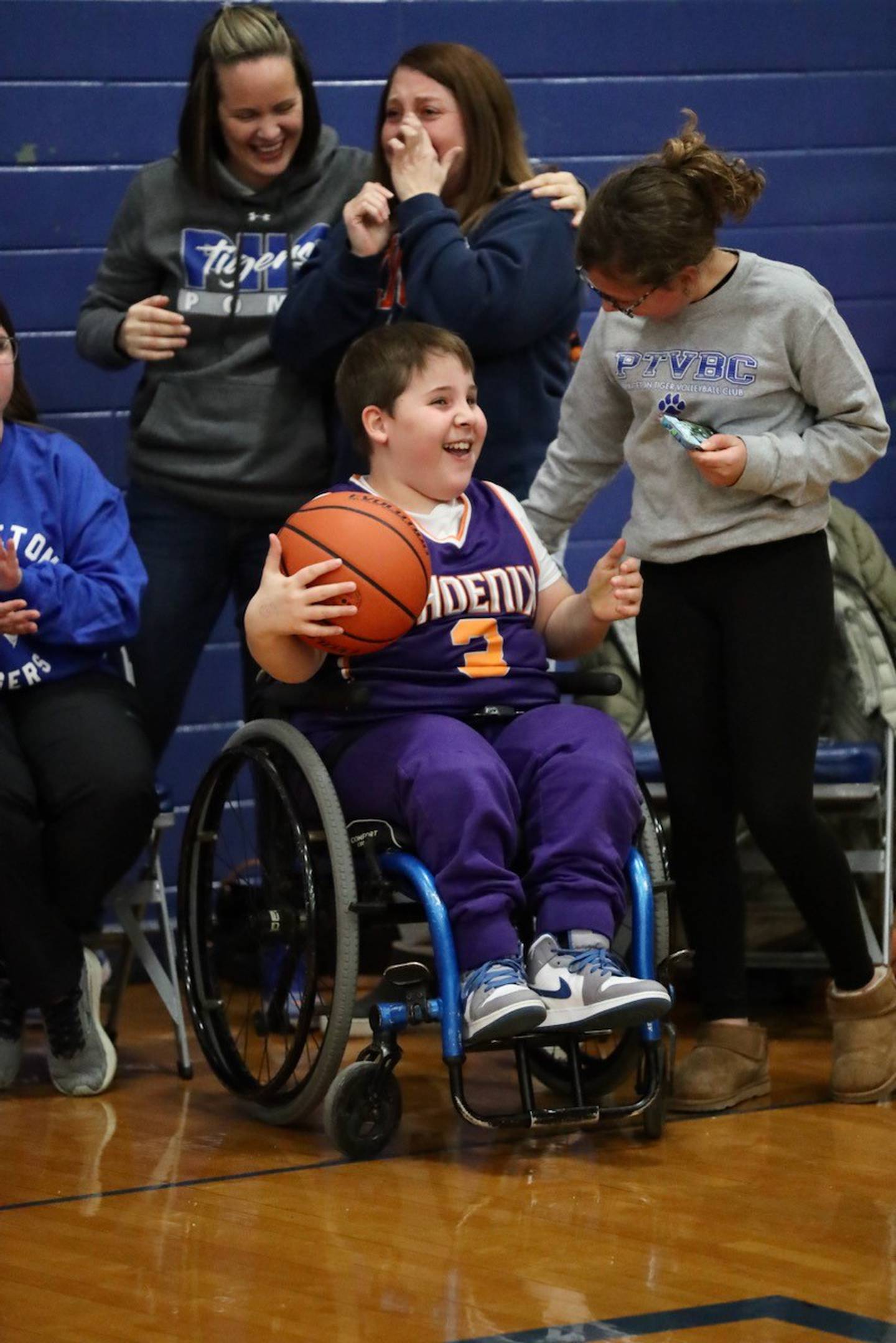 Zane Britton is all smiles after receiving the game ball from Teegan Davis after the Princeton senior scored his 1,000th career in Friday's game against Hall at Prouty Gym.
