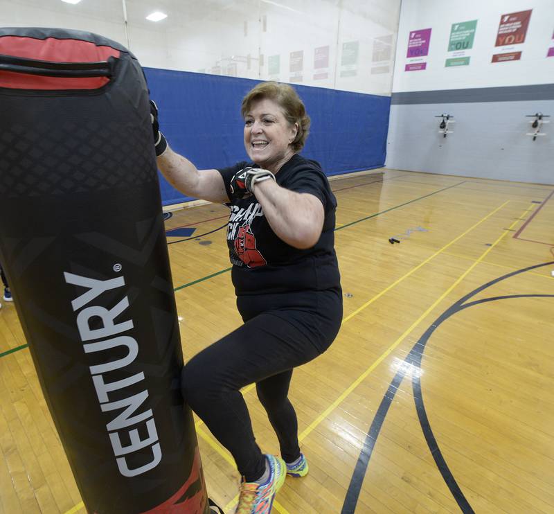 Elaine McKinney punches at a boxing bag during her Rocksteady Boxing class at the Streator YMCA.