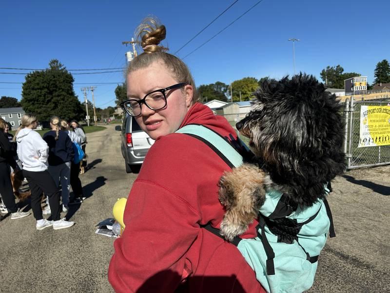 Samantha Adams of Rock Falls carries her 3-year-old pup, Equinox, in a backpack to the 2024 Doggy Dash in Polo on Saturday, Sept. 7, 2024. Equinox is recuperating from a torn ACL, but still wanted to attend the fundraising event.