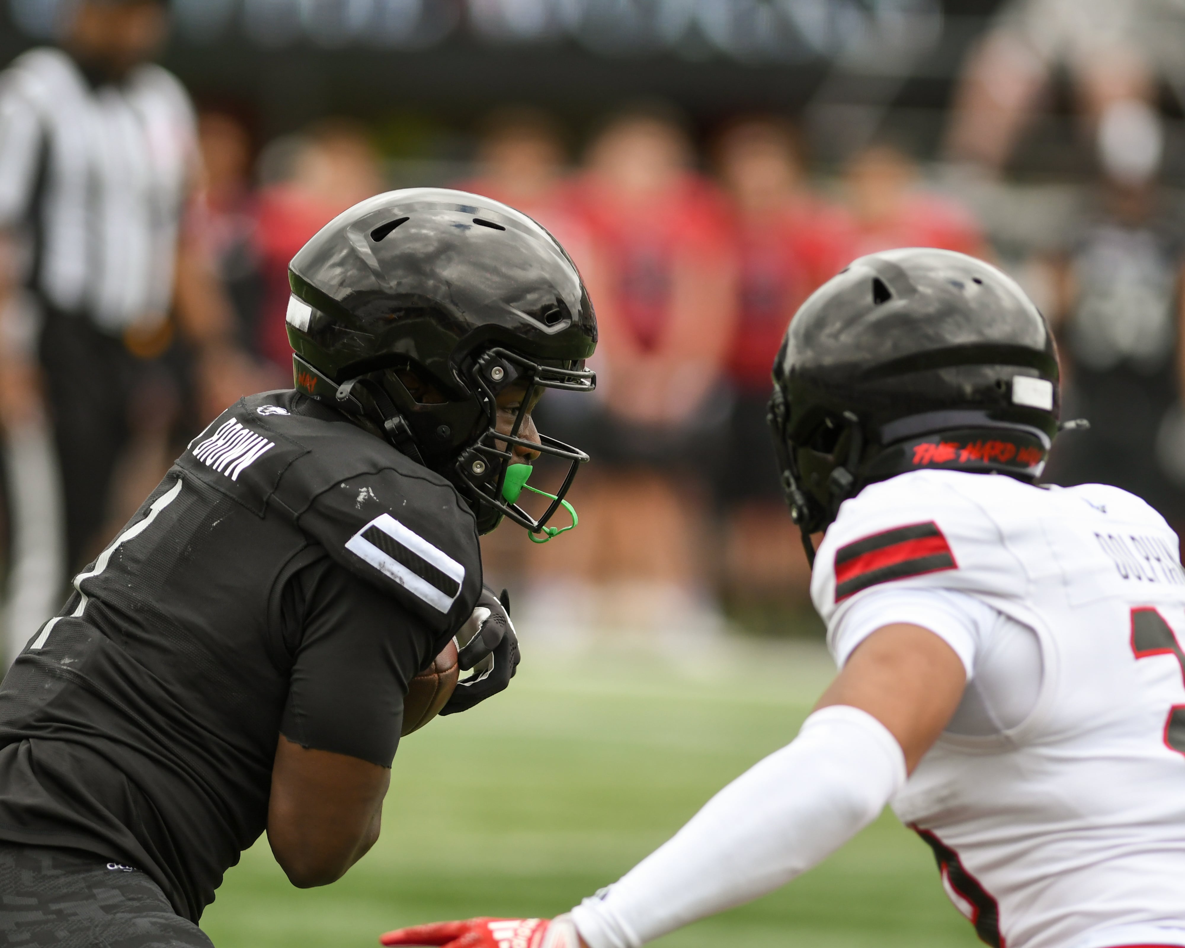 Northern Illinois University's Antario Brown, left, runs the ball while being defended by Jaden Dolphin during scrimmage on Saturday April 27, 2024, held at Huskie Stadium in DeKalb.