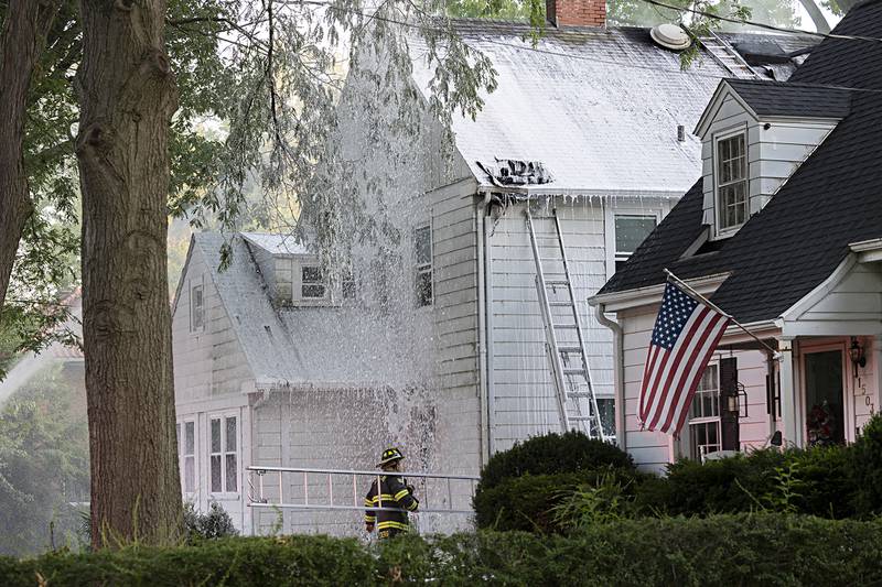 Firefighters use foam to battle a house fire Wednesday, June 26, 2024 at 1501 First Avenue in Sterling. Multiple departments responded to the scene including Sterling, Rock Falls, Dixon, Amboy, Morrison and Prophetstown.