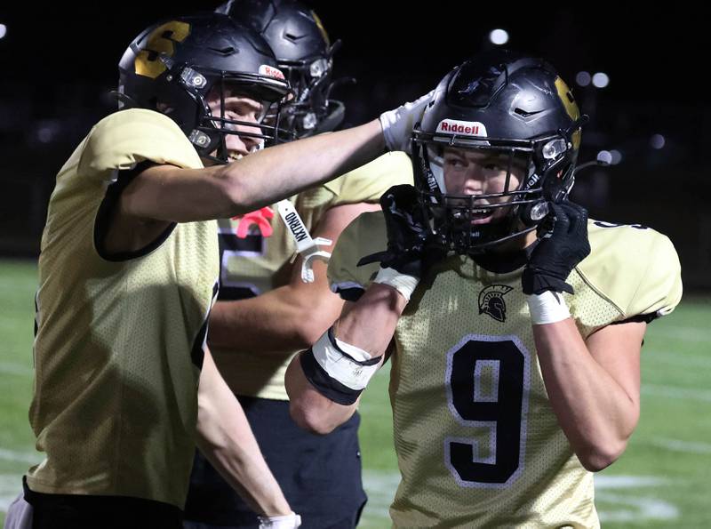 Sycamore's Aidan Wyzard congratulates Caden O’Donnell after he returned an interception for a touchdown during their game against Morris Friday, Oct. 18, 2024, at Sycamore High School.