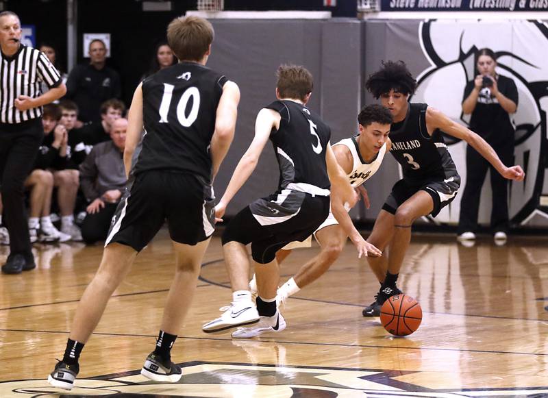 Crystal Lake South's AJ Demirov weaves his way through a trio of Kaneland defenders during the IHSA Class 3A Kaneland Boys Basketball Sectional championship game on Friday, March 1, 2024, at Kaneland High School in Maple Park.