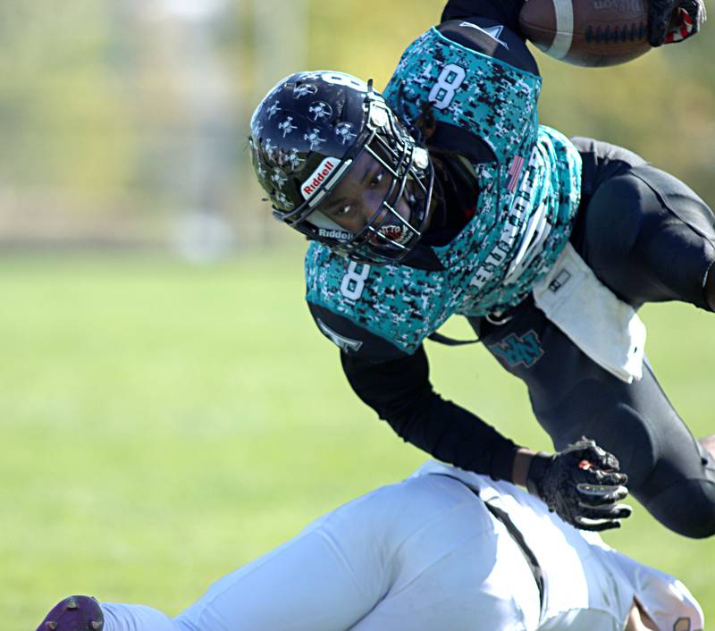 Woodstock North’s  Maxwell Dennison scrambles for yardage against Sycamore in varsity football in Woodstock Saturday.