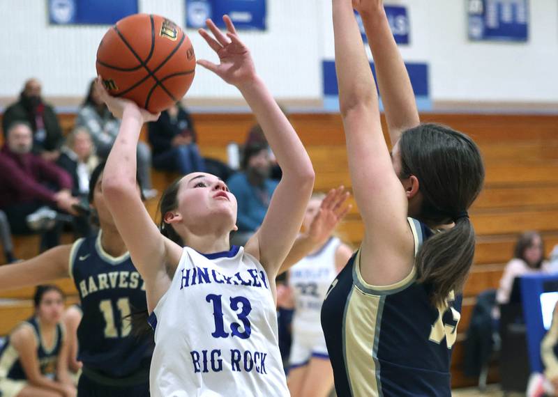 Hinckley-Big Rock’s Mia Cotton shoots over Harvest Christian’s McKenna Nestrick Monday, Jan. 8, 2023, during their game at Hinckley-Big Rock High School.