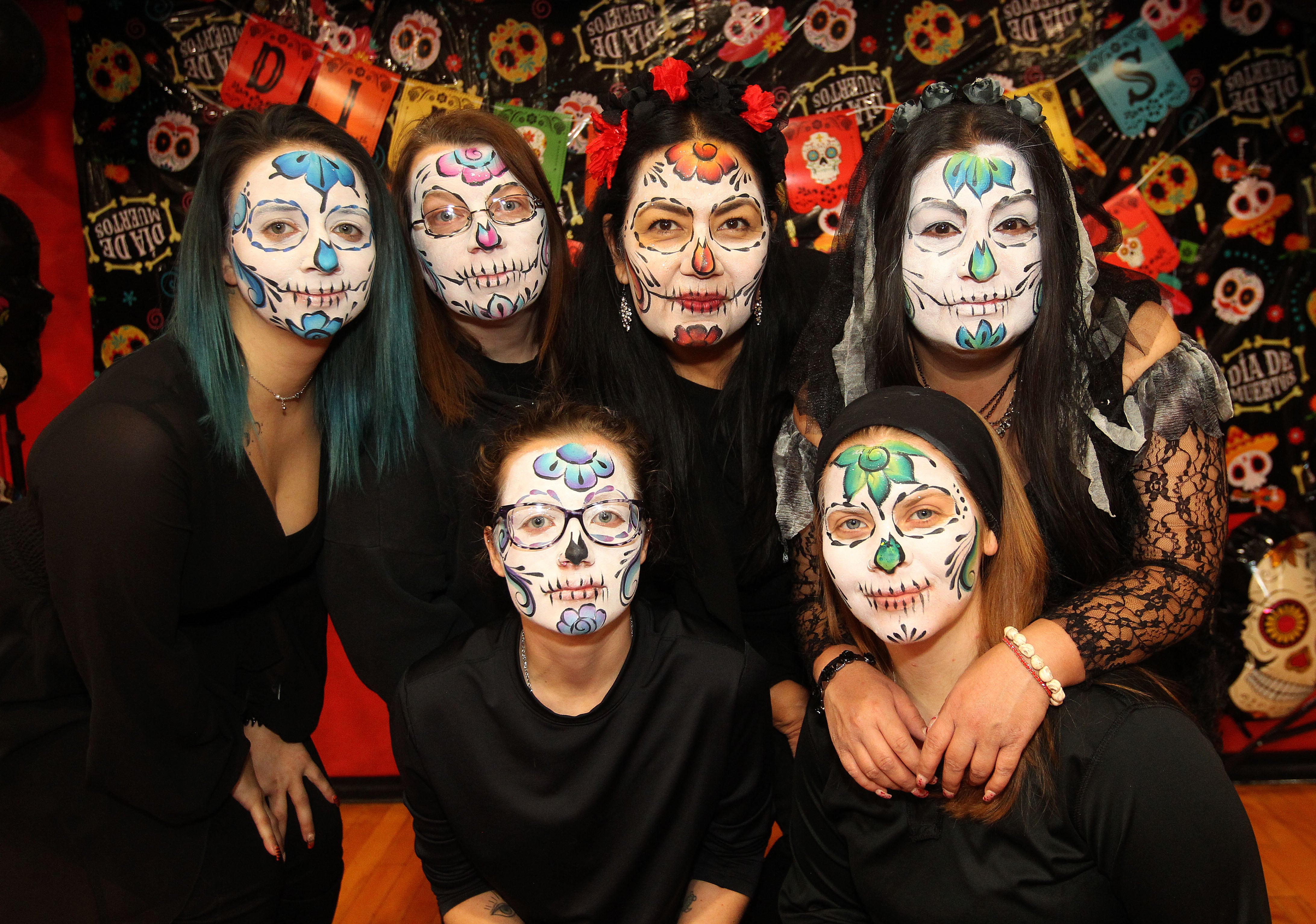 Volunteers, parents & teachers from District 114 show off the Sugar Skull makeup designs they wore on their faces during the Dia de los Muertos, Day of the Dead event at Stanton Middle School on November 4th in Fox Lake. The event was sponsored by the Bilingual Parents Advisory Committee (BPAC) from School Districts 114,124 and 37.
Photo by Candace H. Johnson for Shaw Local News Network