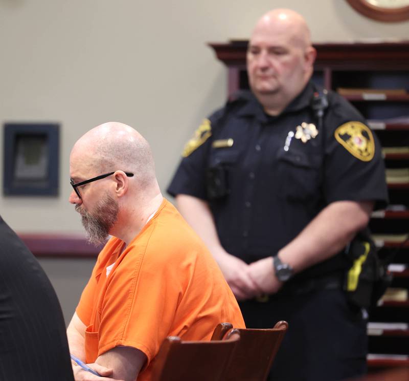 A DeKalb County Sheriff’s Deputy keeps an eye on Jonathan Hurst in Judge Marcy Buick’s courtroom at the DeKalb County Courthouse in Sycamore Monday, April 29, 2024 during a hearing on his case. Hurst is charged with murder in the August 2016 slayings of mother and son, Patricia A. Wilson, 85 and Robert J. Wilson, 64, of Sycamore.