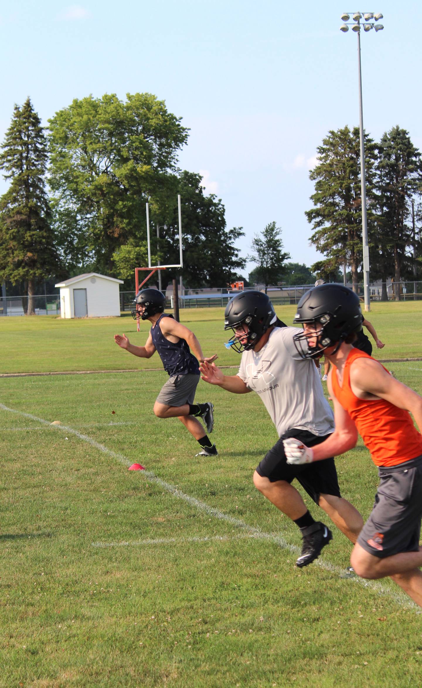 Flanagan-Cornell/Woodland's (from left) Aydan Radke, Calix Stout and Connor Reed sprint during FCW's first summer camp day Monday, July 22, 2024, in Flanagan.