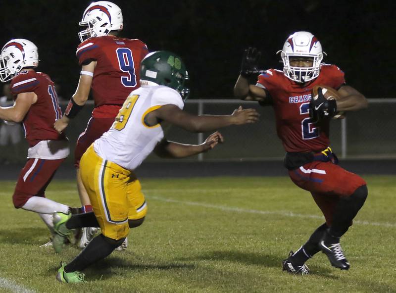 Dundee-Crown's Terrion Spencer runs away from Crystal Lake South’s Christian Avery during a Fox Valley Conference football game on Friday, Aug 30, 2024, at Dundee-Crown High School in Carpentersville.