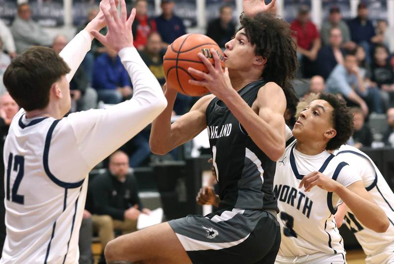 Kaneland's Evan Frieders goes to the basket between two Belvidere North defenders Wednesday, Feb. 28, 2024, during their Class 3A sectional semifinal game at Kaneland High School in Maple Park.