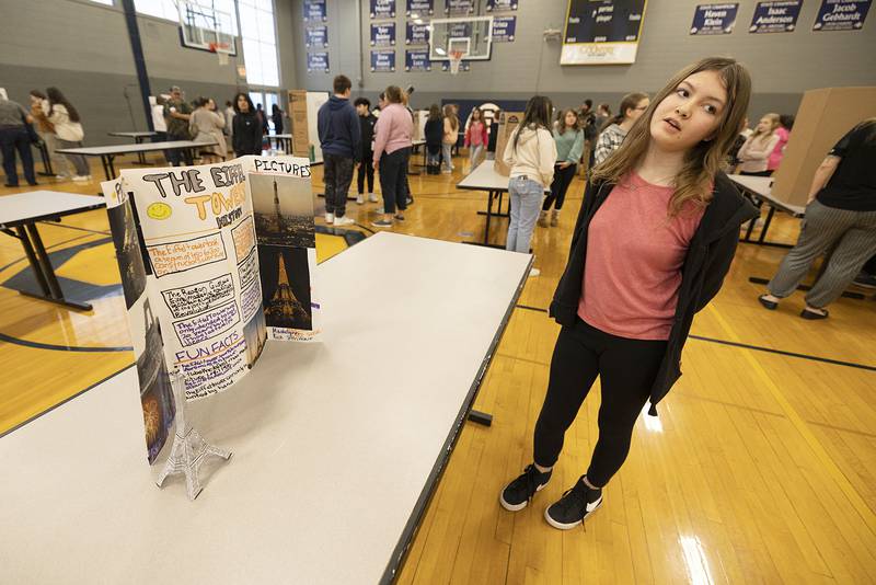 Madelyn Rice, sixth grader, discusses her display on the Eiffel Tower during a STEM exhibit at Challand Middle School in Sterling Thursday, March 9, 2023. Rice found the most interesting fact was that the tower rises to 1,063 feet.