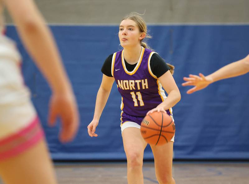 Downers Grove North’s Abby Gross (11) scans the court against Lyons Township during the girls varsity basketball game on Tuesday, Jan. 16, 2024 in La Grange, IL.