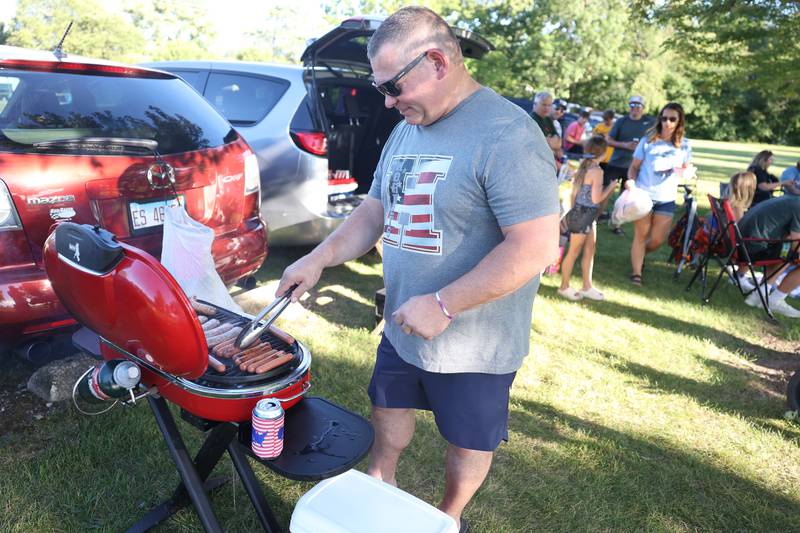 Adam Anderson works the grill at Dellwood Park in Lockport on Wednesday July 3, 2024.