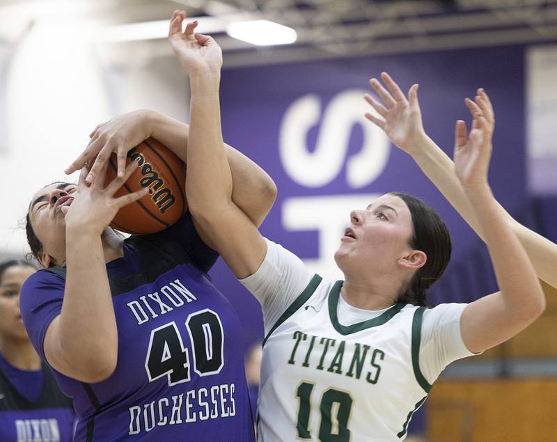 Dixon’s Hallie Williamson snags a rebound against Boylan’s Gianna Marinaro Friday, Feb. 16, 2024 at the class 3A Rochelle girls basketball regional.