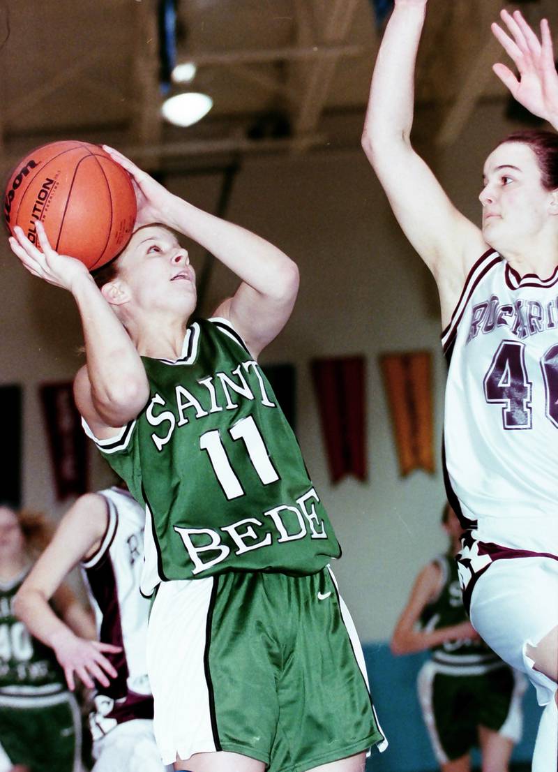 St. Bede's Karisa Dinges eyes the hoop over a Rockridge player during the Sectional game on Feb. 14, 2000.