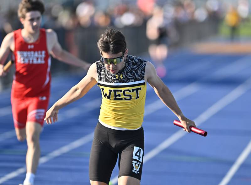 Joliet West's Joshua Calvert crosses the finish line in the 4x200 relay during the IHSA 3A Sectional track meet  on Friday, May. 17, 2024, at Joliet.