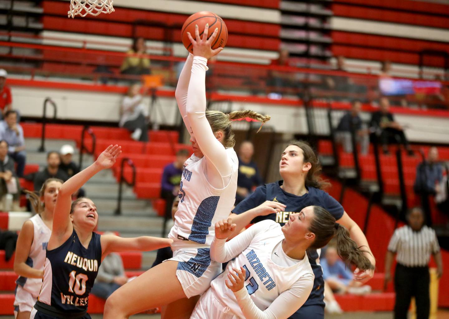 Nazareth’s Olivia Austin comes down with the rebound over teammate Danielle Scully during a game against Neuqua Valley at Hinsdale Central on Thursday, Nov. 16, 2023.