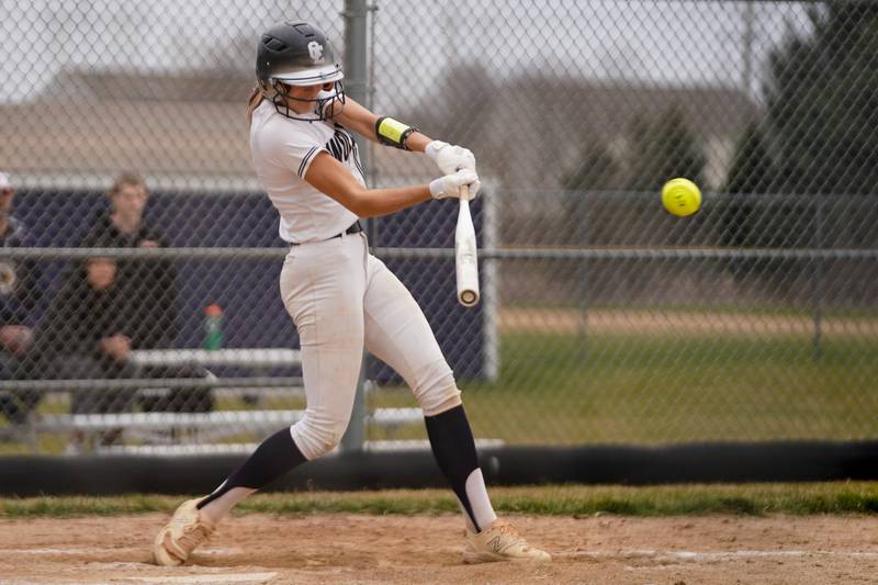 Oswego East's Ronnie Craft (6) slaps a single against St. Charles East during a softball game at Oswego East High School on Wednesday, March 13, 2024.