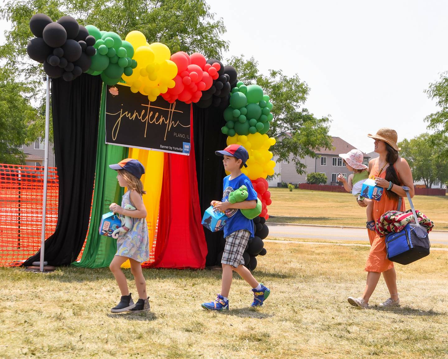 Family members Sofia, 5 years old, Silas, 8 years old along with Sayla, 2 years old, and mom Samantha Wood walk enter the festivities ground of the Juneteenth celebration held at Emily G. Johns school in Plano on Saturday June 17, 2023.