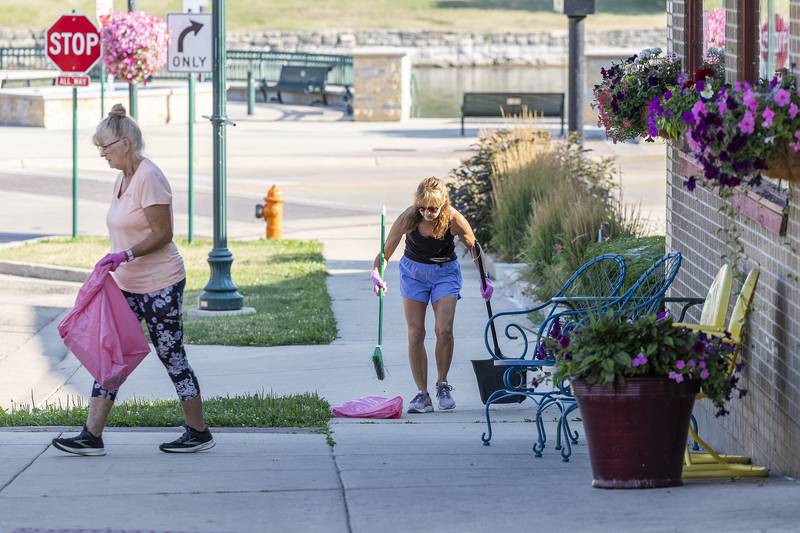 Deb Cashman (left) and Paula Sherman get to work cleaning the streets of Dixon Thursday, July 6, 2023. Dixon Chamber’s Beautify Dixon committee organizes a monthly cleanup to keep the city spiffy.