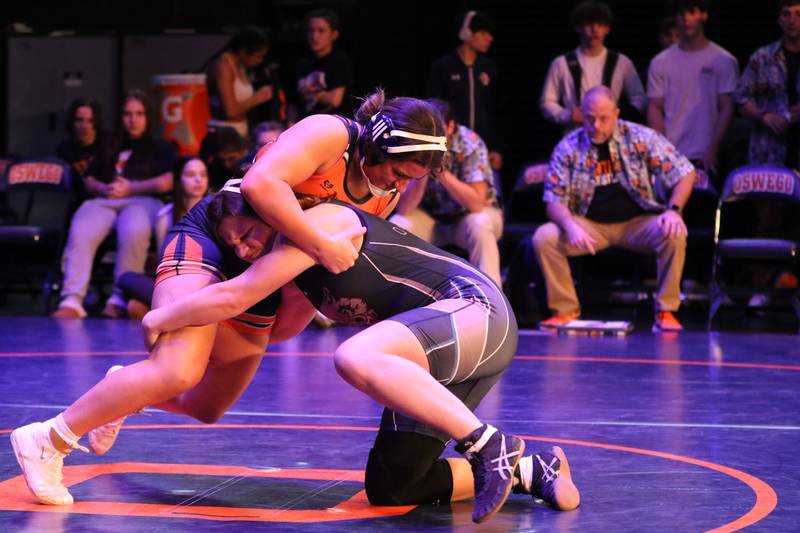 Oswego High School student Kya Chavez and Oswego East High School student Ella Cooper OEHS wrestle in a crosstown duel. Girls currently compete in the Oswego School District boys wrestling program.