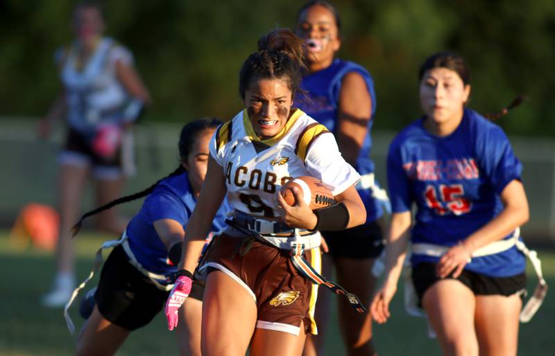 Jacobs’ Brie Verburg runs the ball in varsity flag football on Tuesday, Sept. 3, 2024, at Dundee-Crown High School in Carpentersville.