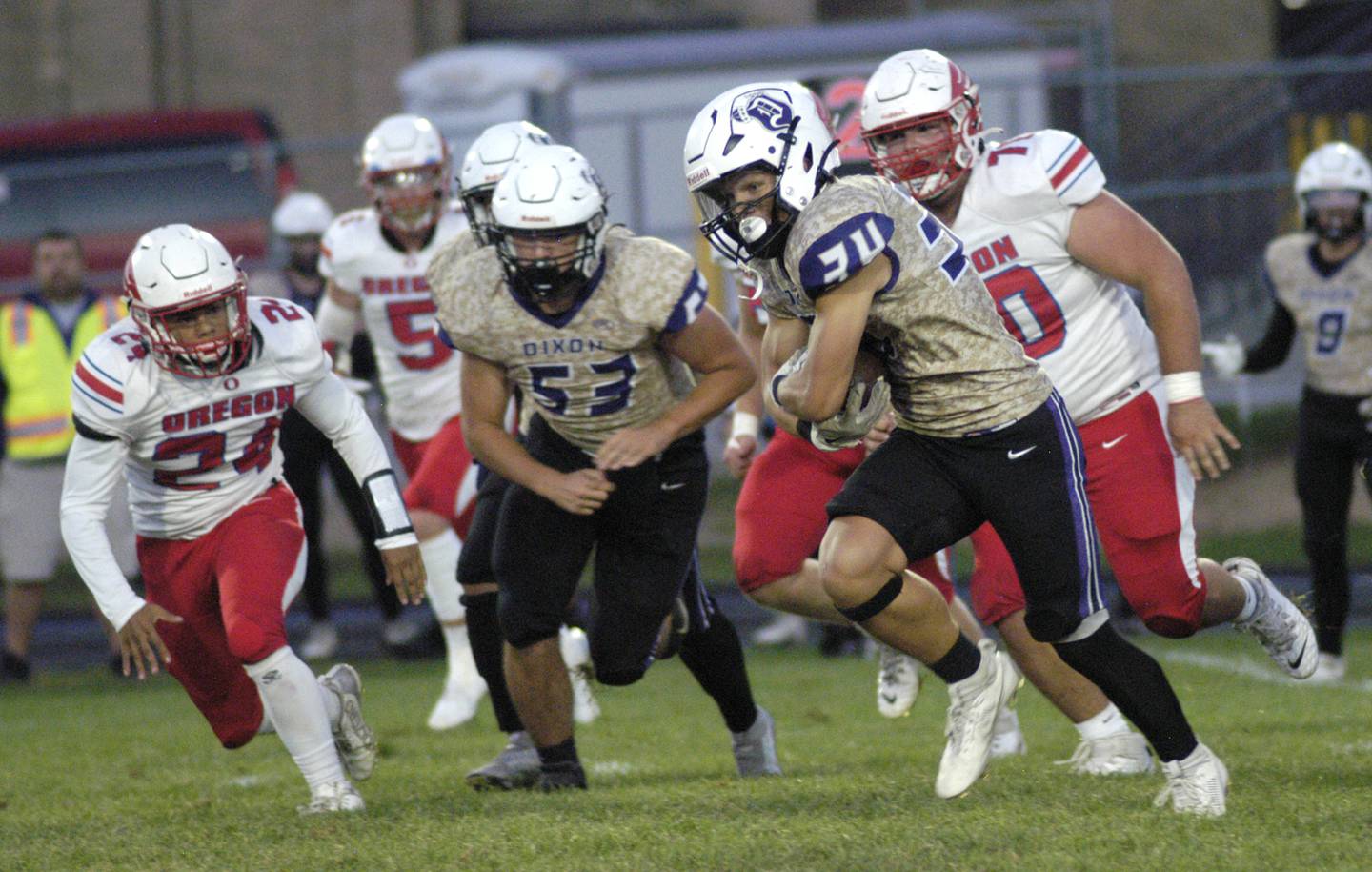 Dixon  running back Owen Belzer picks up yardage against Oregon. Oregon traveled to AC Bowers field to play the Dukes on Friday, Sept. 7,2024