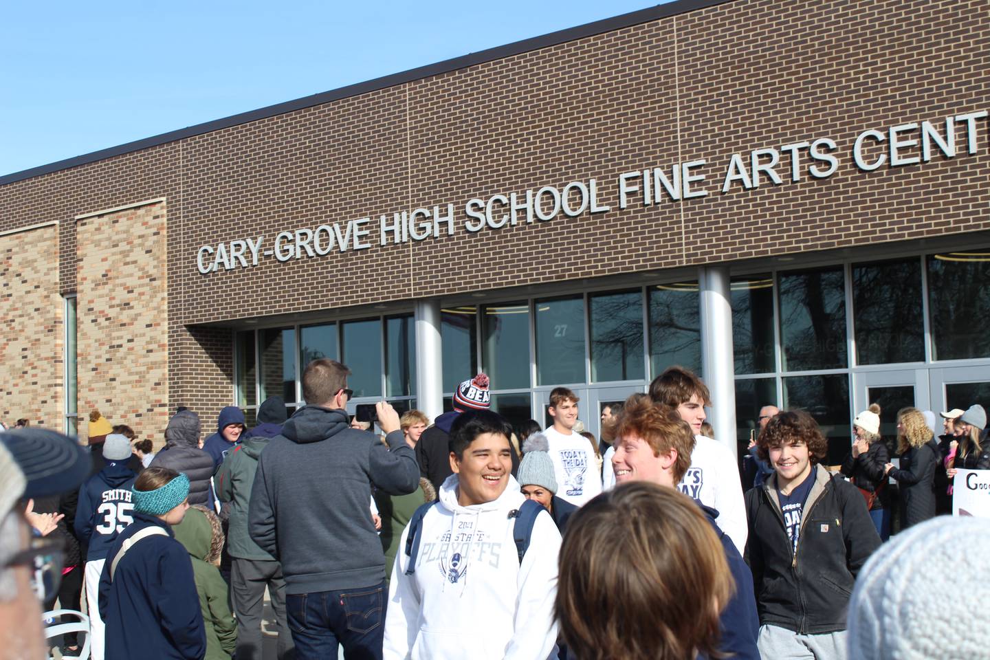 Cary-Grove football team walks past friends, family and friends as they board the bus to the state championship game Friday.