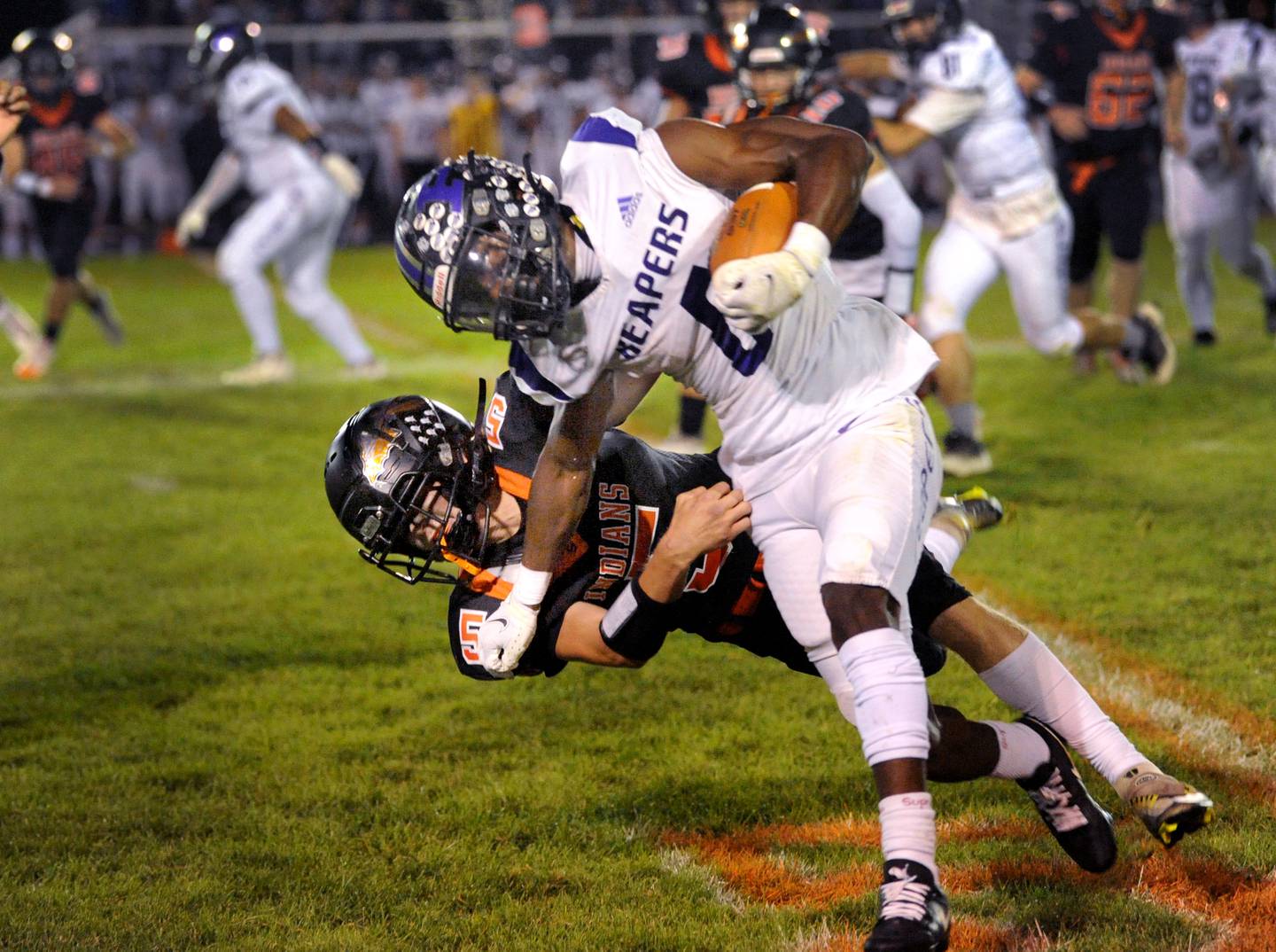 Plano running back Waleed Johnson (6) gains a first down before being tackled by Sandwich defender Cole Leeper (5) during a varsity football game at Sandwich High School on Friday, Sept. 8, 2023.