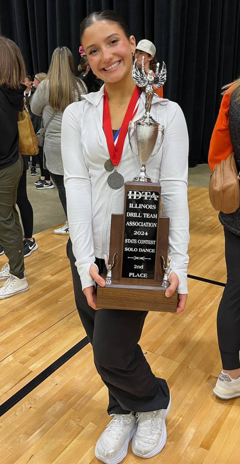 Ottawa High School's Sophie Fernandez proudly displays her award for placing second at the Illinois Drill Team Association solo dance competition in Springfield on Feb. 10.