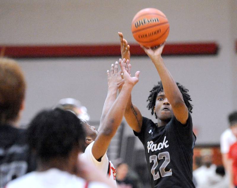 Oswego East's Jehvion Starwood (22) puts up a shot over Yorkville defender Dayvion Johnson during a varsity basketball game at Yorkville High School on Friday, Feb. 9, 2024.