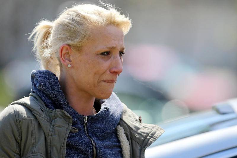 JoAnn Cunningham, mother of missing 5 year old Andrew "AJ" Freund, holds back tears April 19 as she talks with the media outside Cunningham's home on Dole Avenue in Crystal Lake.