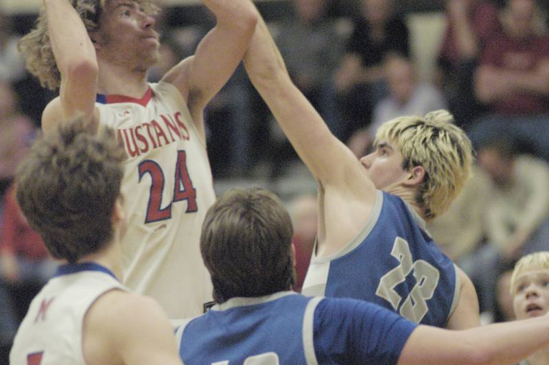 Morrison's Brenden shoots over Princeton's Noah Laporte during the Morrison vs Princeton class 2A basketball regional final at Prophetstown High School on Friday, Feb. 23 .