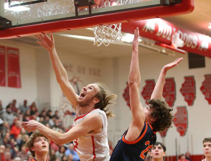 Streator's Quinn Baker sinks a reverse layup over Pontiac's Riley Weber during the Class 3A Regional semifinal game on Wednesday, Feb. 22, 2024 at Pops Dale Gymnasium.