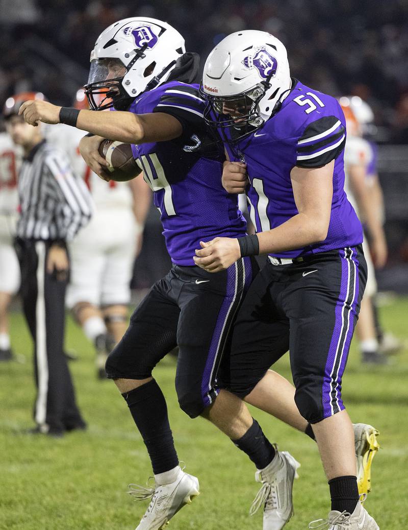 Dixon’s Carter Kibble and Chase Simpson celebrate a fumble recovery against Byron Friday, Oct. 18, 2024, at A.C. Bowers Field in Dixon.