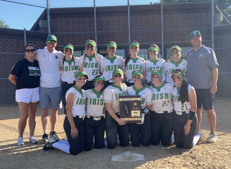 The Seneca Fighting Irish softball team poses with its freshly won Class 2A regional championship plaque Friday, May 17, 2024, in Seneca.