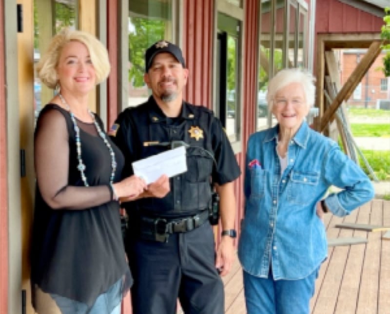 (From left) Erin Stuedemann donates funds to Seneca Police Chief Scott Cruz, along with Starved Rock Country Community Foundation Board Member Norma Cotner.