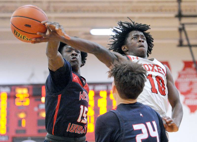 Yorkville's Kaevian Johnson (1)) takes a nasty foul from West Aurora defender Kewon Marshall (15) during a class 4A regional semifinal basketball game at Yorkville High School on Wednesday, Feb. 21, 2024.