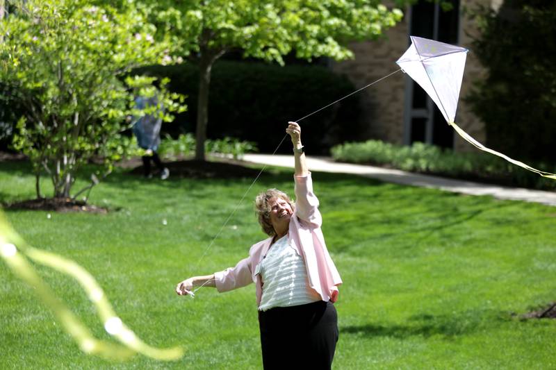 Sue McCoy, vice president and chief nurse executive at Northwestern Medicine Central DuPage Hospital in Winfield, flies a kite in the courtyard as part of National Nurses’ Week festivities on Wednesday, May 10, 2023.