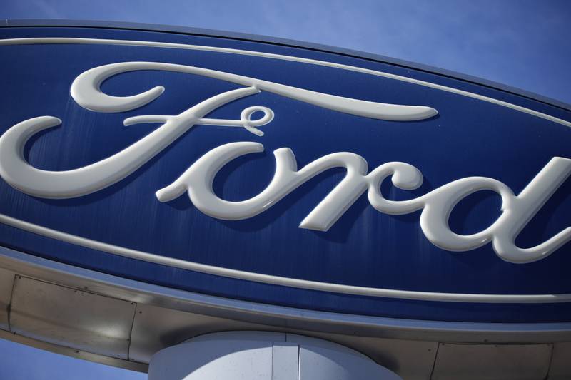 FILE - This Oct. 24, 2021 file photo shows a Ford company logo on a sign at a Ford dealership in southeast Denver.  Ford is recalling more than 550,000 pickup trucks in the U.S., Tuesday, June 25, 2024, because the transmissions can unexpectedly downshift to first gear no matter how fast the trucks are going. The recall covers certain F-150 pickups from the 2014 model year. Ford's F-Series pickups are the top-selling vehicles in the U.S.  (AP Photo/David Zalubowski, File)