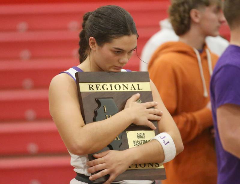 Serena's Paisley Twait cradles the Class 1A Regional plaque after defeating Ashton-Franklin Center on Thursday, Feb. 15, 2024 at Earlville High School.