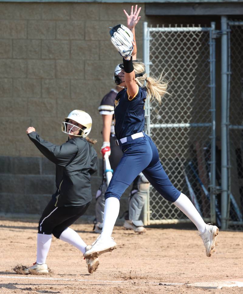 Sycamore's Keera Trautvetter is safe at first with a base hit as Sterling's Ady Waldschmidt has to go up to catch the high throw from the outfield during their game Tuesday, May 14, 2024, at Sycamore High School.