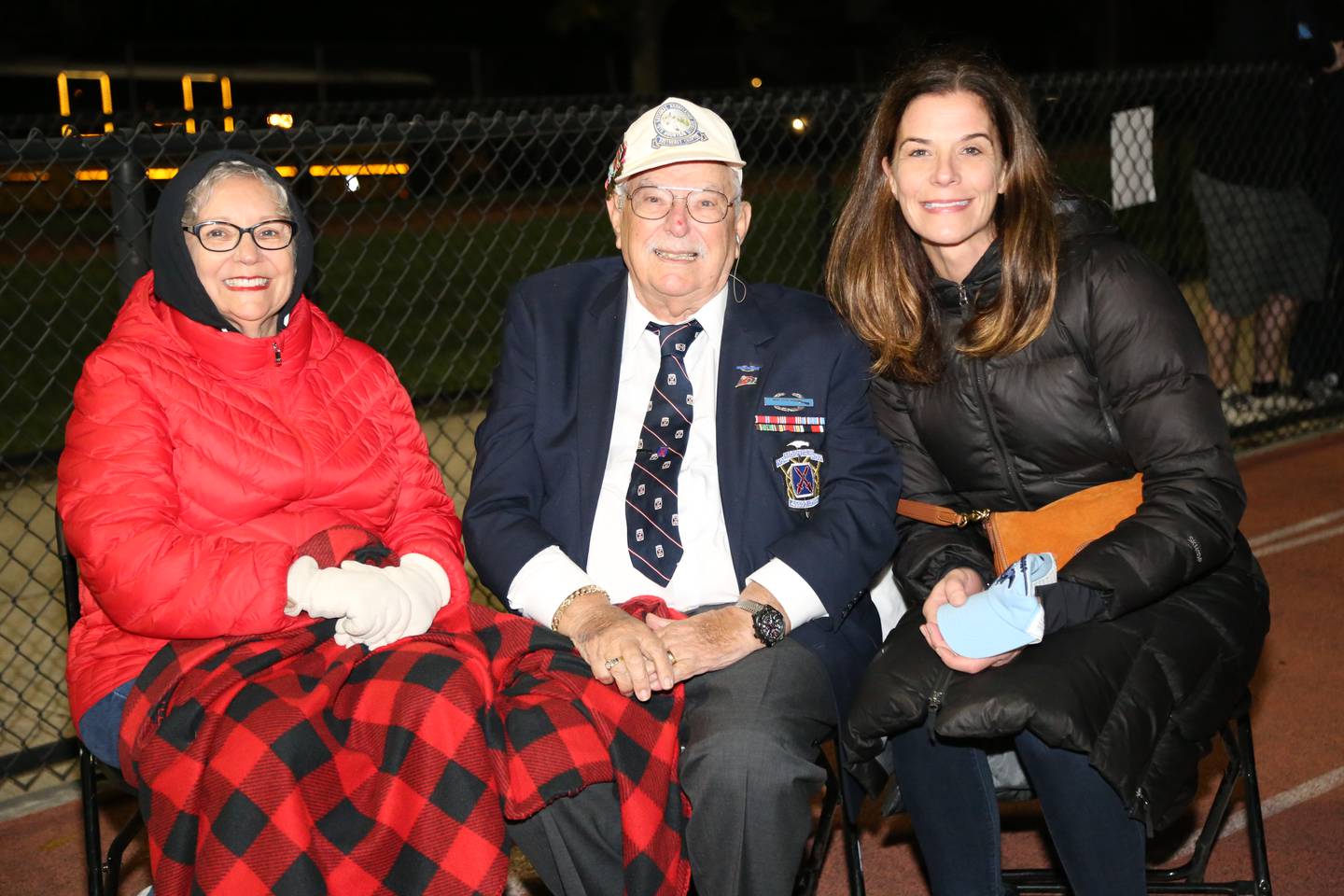 World War II veteran Jake Pollak, 92, was honored during halftime of a Downers Grove South High School football game. Pollack, a member of South's Class of 1944, served with the Army's 10th Mountain Division in Italy through the end of the war. Pollack is joined by his daughter Sharon Green, left, and Lisa Manecke, a neighbor and friend.